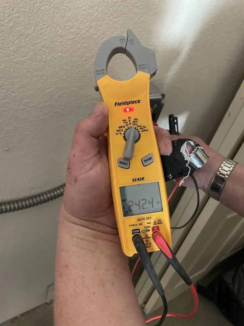 Voltage testing with clamp meter during Outlet Installation in Brandermill